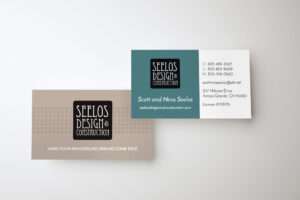 Business card design for Seelos Design & Construction, printed on high-quality cardstock with a clear UV spot finish, featuring contact details and branding.