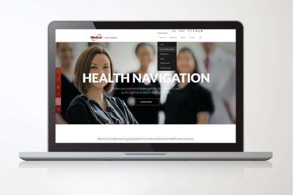 A laptop screen displaying health company website, featuring a smiling healthcare professional in focus, with a blurred team in the background. Highlights expertise in graphic design, information design, and infographics for healthcare services.