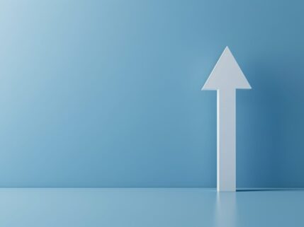 Minimalist white arrow pointing upward on a blue background, symbolizing growth and progress